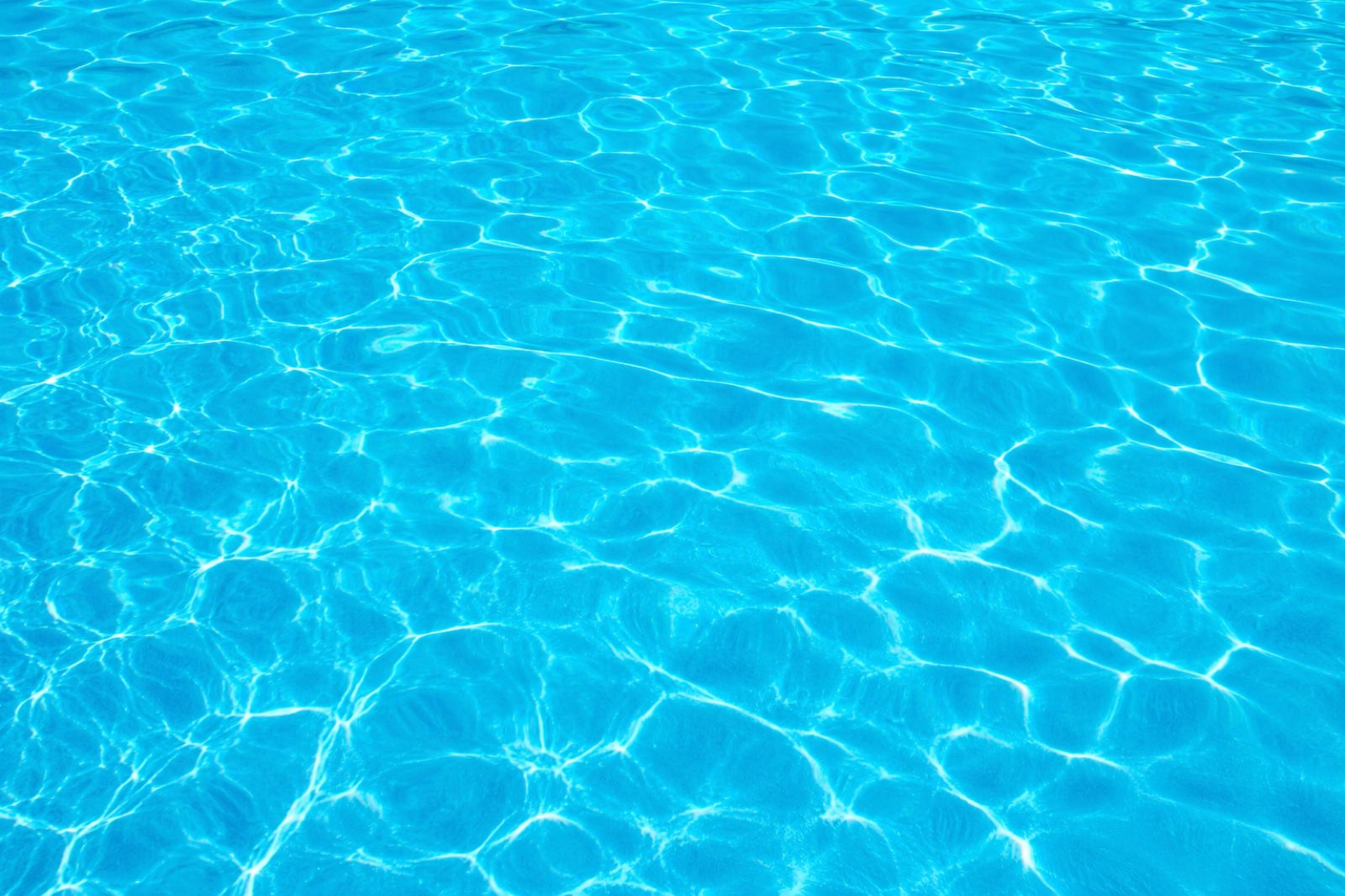 Sunlit ripples on clear pool water